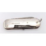 An Antique Sterling Silver Pocket Knife. Sterling silver exterior with four utensil item interior