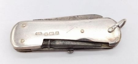An Antique Sterling Silver Pocket Knife. Sterling silver exterior with four utensil item interior