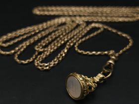 An Antique 9K Yellow Gold Long Pocket Watch Chain with a Hanging 9K Yellow Gold Fob with