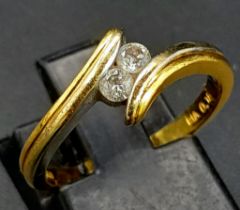 AN 18K YELLOW GOLD DIAMOND 2 STONE TWIST RING. Size L, 0.15ctw, 3.3g total weight.