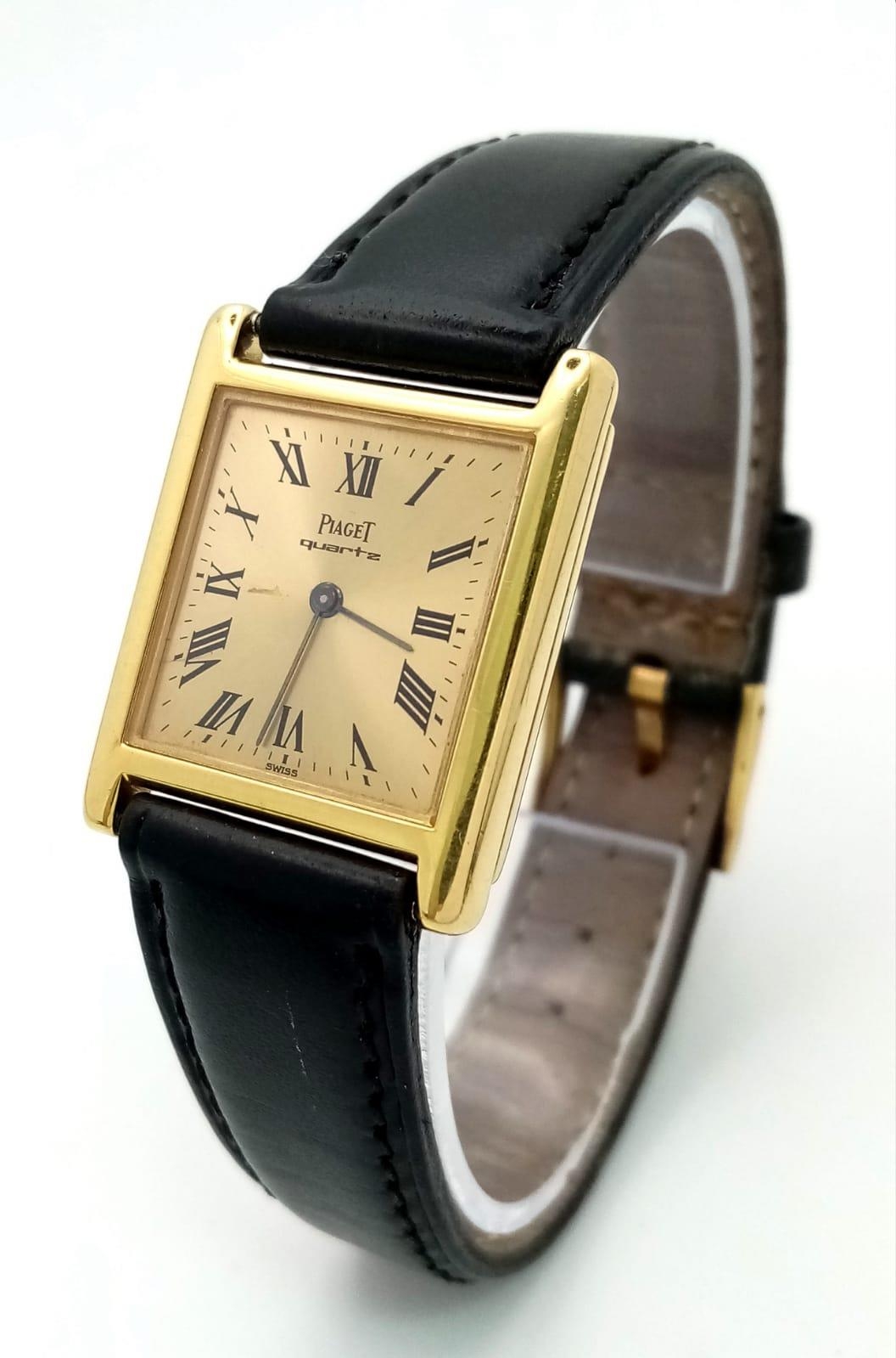 A Vintage 18k Gold Piaget Quartz Ladies Watch. Black leather strap with 18k gold buckle. 18k gold