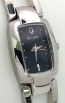 A Bulova Quartz Ladies Watch. Stainless steel bracelet and case - 18mm. Black dial. In working