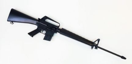 A Deactivated Black M16 .22LR Rifle. Cocks under spring pressure. 60cm barrel length. 112cm total