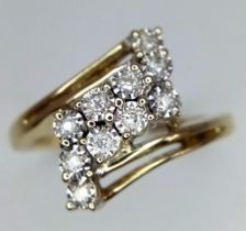 A Vintage 9K Yellow Gold Diamond Orbital Ring. Ten diamonds on an orbital crossover pattern. Size N.
