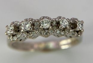 A Vintage 18K White Gold Five Stone Diamond Ring. Five brilliant round cut diamonds each with its
