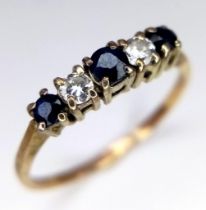 A 9K YELLOW GOLD DIAMOND & SAPPHIRE 5 STONE ETERNITY RING. There are three round cut blue