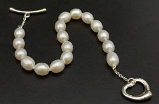 A Tiffany and Co. Pearl and 925 Silver Heart Clasp Bracelet. Comes with paperwork. 18cm length. Ref: