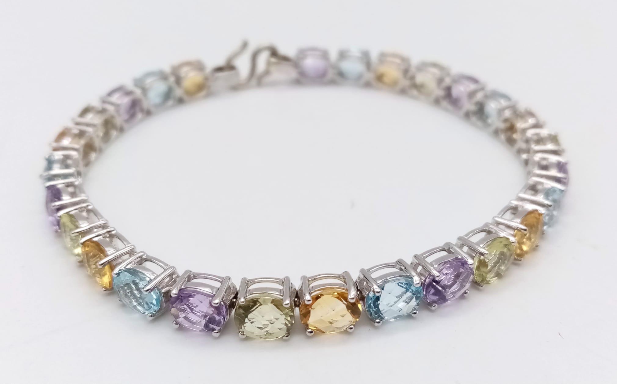 A 9K White Gold Multi-Gemstone Tennis Bracelet. Includes beautifully oval-cut faceted amethyst,