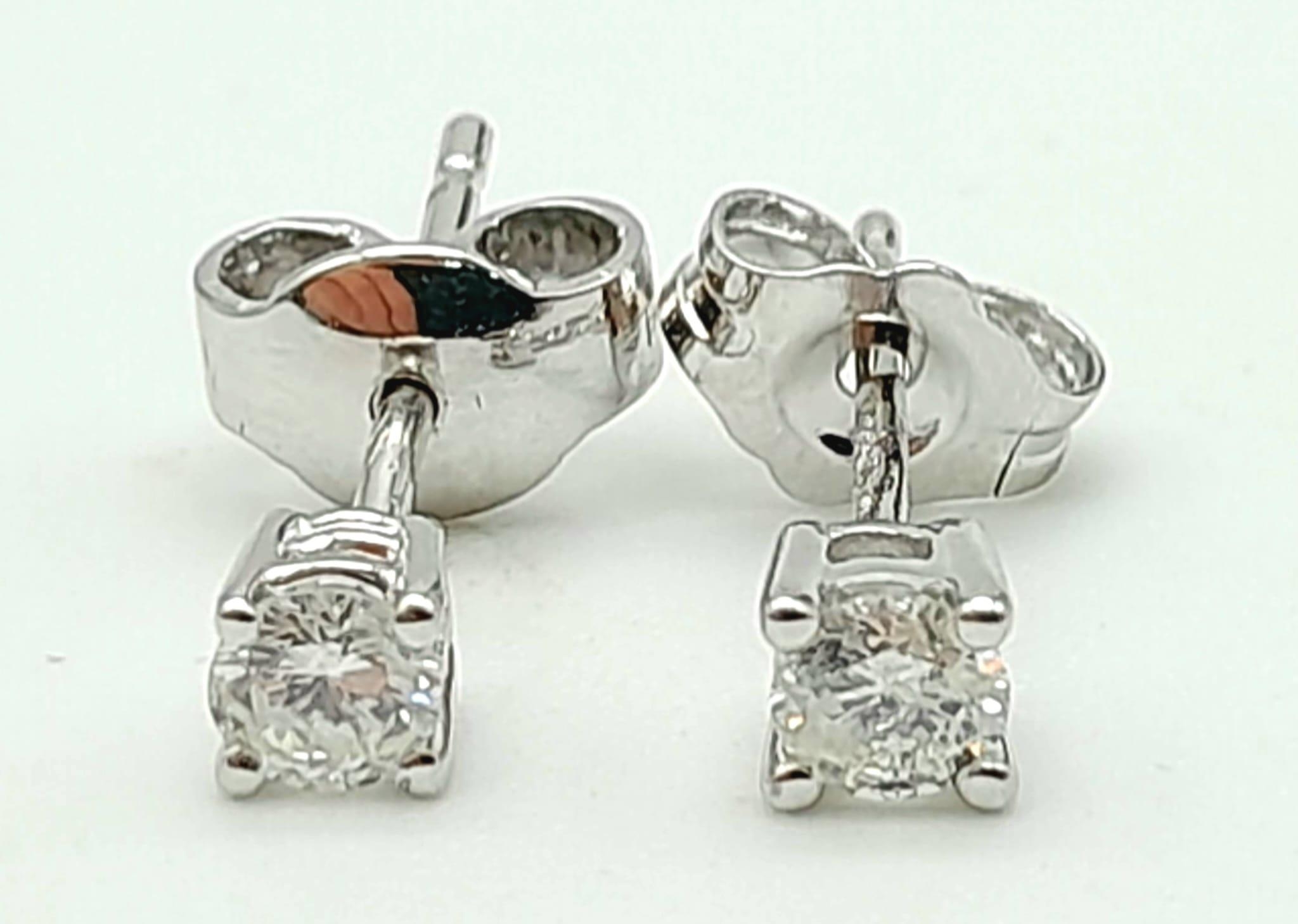 A Pair of 18K White Gold Diamond Stud Earrings. 1g total weight.