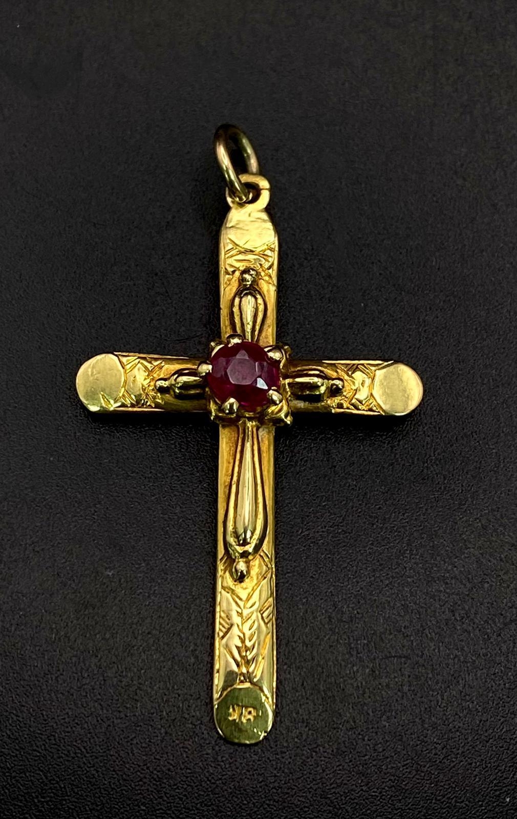 An 18K Yellow Gold Crucifix and Ruby Pendant. Central ruby representing the blood of Christ. 4.5cm x