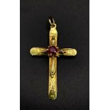 An 18K Yellow Gold Crucifix and Ruby Pendant. Central ruby representing the blood of Christ. 4.5cm x