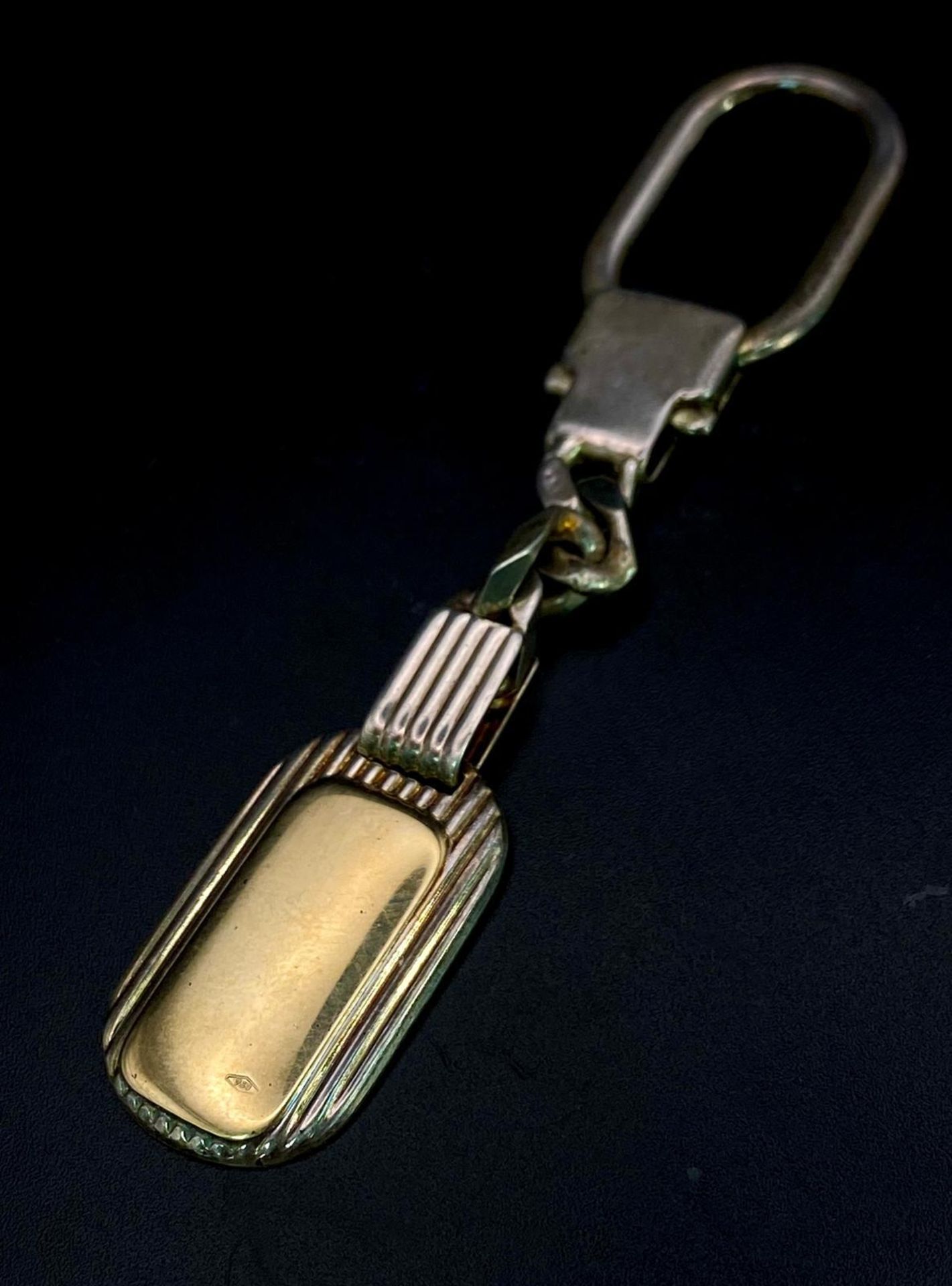 A Vintage Sterling Silver and 18K Gold Key Ring. Constructed from different parts of previous