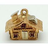A 9K White and Yellow Gold House Pendant/Charm with Pink Topaz Decoration. 15mm. 4.53g weight.