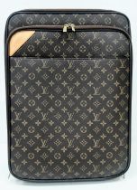 A Louis Vuitton Monogram Pegase Suitcase. Durable leather exterior. Front compartment with zipper,