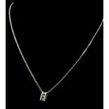 An 18K White Gold and Three Diamond Pendant on a 9K White Gold Necklace. 0.10ctw - three diamonds.