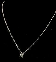 An 18K White Gold and Three Diamond Pendant on a 9K White Gold Necklace. 0.10ctw - three diamonds.