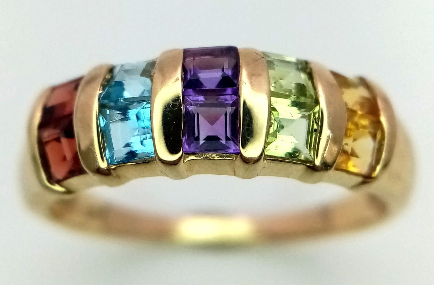 A 9K YELLOW GOLD GEM SET RING. Includes peridot, garnet, topaz, amethyst and citrine. Size P, 2.4g - Image 2 of 4