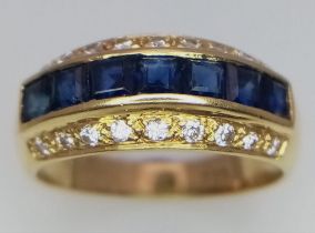 An 18K Yellow Gold Sapphire and Diamond Ring. A band of seven square cut sapphires with diamonds
