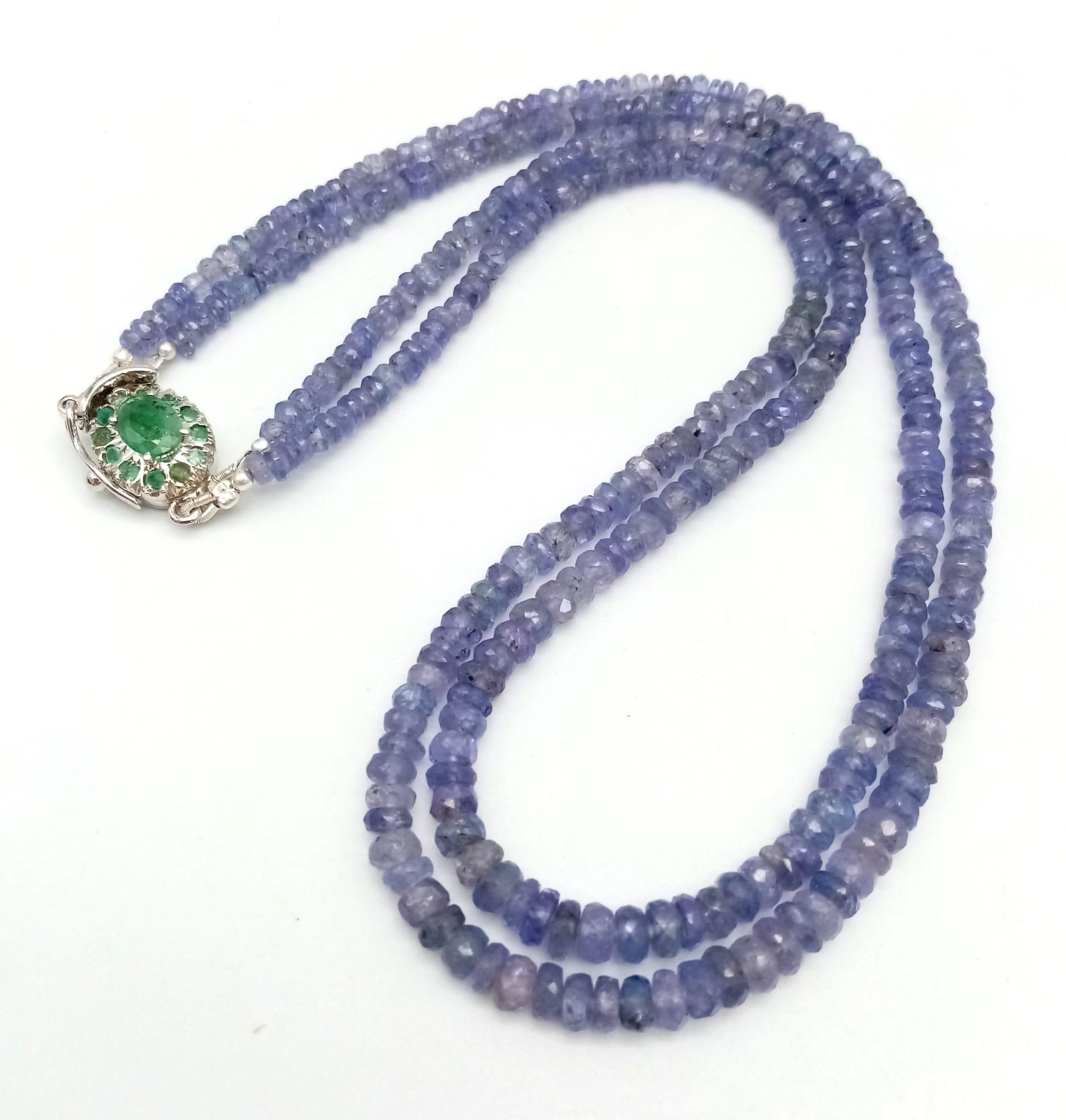 A Two Row Tanzanite Gemstone Necklace with an Emerald and 925 Silver Clasp. 45cm in length, 175ctw