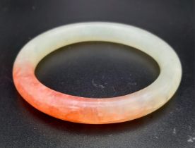 Boxed Jade bangle. Beautiful powdered green with red highlights. 8cms in diameter.