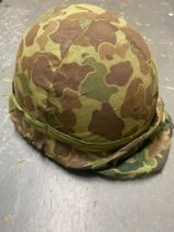 A WW2 USA Marine Corps Front Sean M1 Helmet with a Westinghouse Liner. There are numbers at the