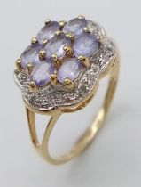 9k yellow gold tanzanite and diamond flower cluster ring. Weight: 3.1g Size Q (dia:0.06ct/tanz:1.