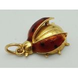 An 18K Yellow Gold and Enamel Ladybird Pendant. 2cm. 2.05g total weight.