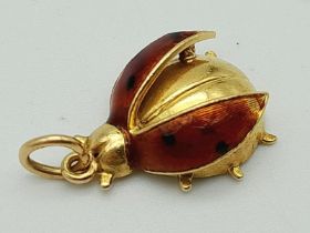 An 18K Yellow Gold and Enamel Ladybird Pendant. 2cm. 2.05g total weight.