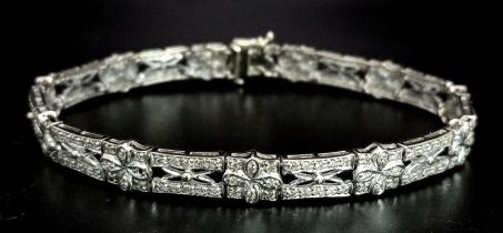 A Vintage 18K White Gold and Diamond Bracelet. 1.8ctw of diamonds spread over ornate and pierced