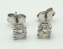 A Superb Pair of 18K White Gold Diamond Stud Earrings. 0.80ctw of brilliant round cut diamonds. 1.