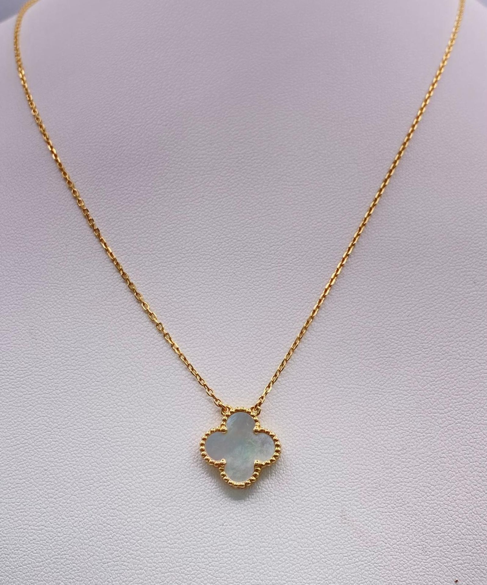 An 18K Yellow Gold and Mother of Pearl Clover Pendant on an 18K Gold Necklace. 17mm and 42cm. 4.6g