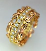 A FABULOUS ""CLOGAU"" 18K ROSE AND YELLOW GOLD RING HAVING A CENTRAL BAND OF CHANNEL SET WHITE AND