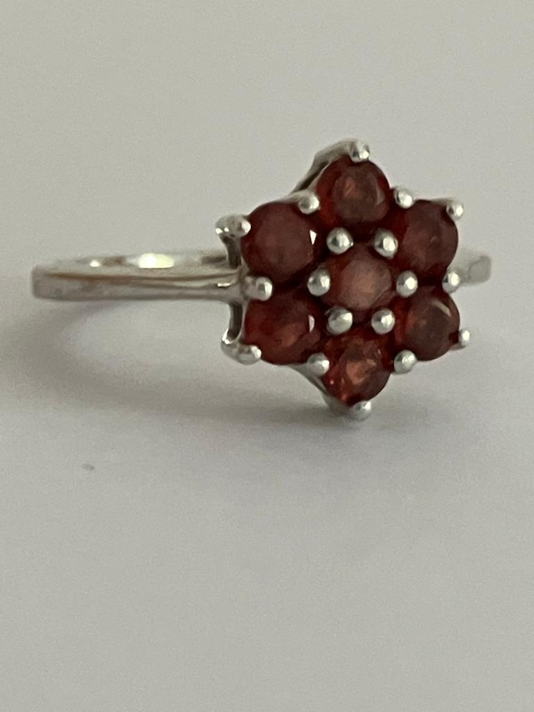 RED TOURMALINE CLUSTER RING Having seven gemstones set in floral/star formation. mounted in 925 - Image 2 of 3