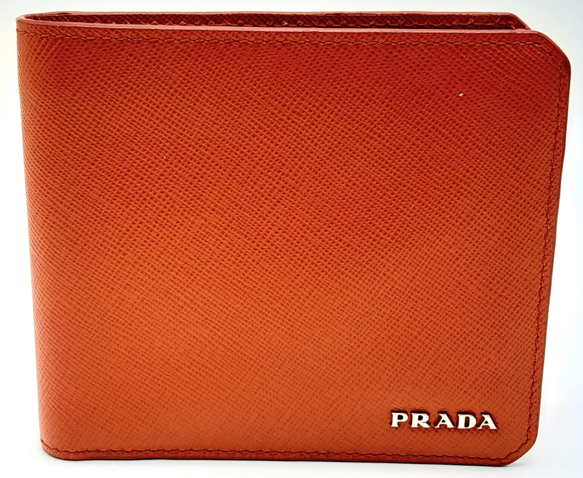 A Prada Burnt Orange Wallet. Leather exterior and interior, with silver-toned logo hardware. Two - Image 3 of 6