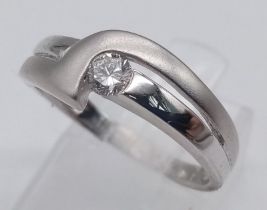 AN 18K WHITE GOLD MATTE AND POLISHED DIAMOND SOLITAIRE RING. Size M, 0.15ct diamond, 3.3g total