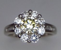 A 950 Platinum Yellow Diamond Ring. A vibrant VVS-2 0.83ct brilliant cut round yellow diamond with a