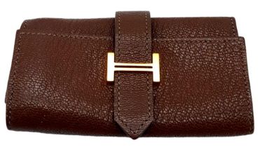 A Hermes Brown Bearn Key Case. Leather exterior and interior, with gold-tone logo hardware on