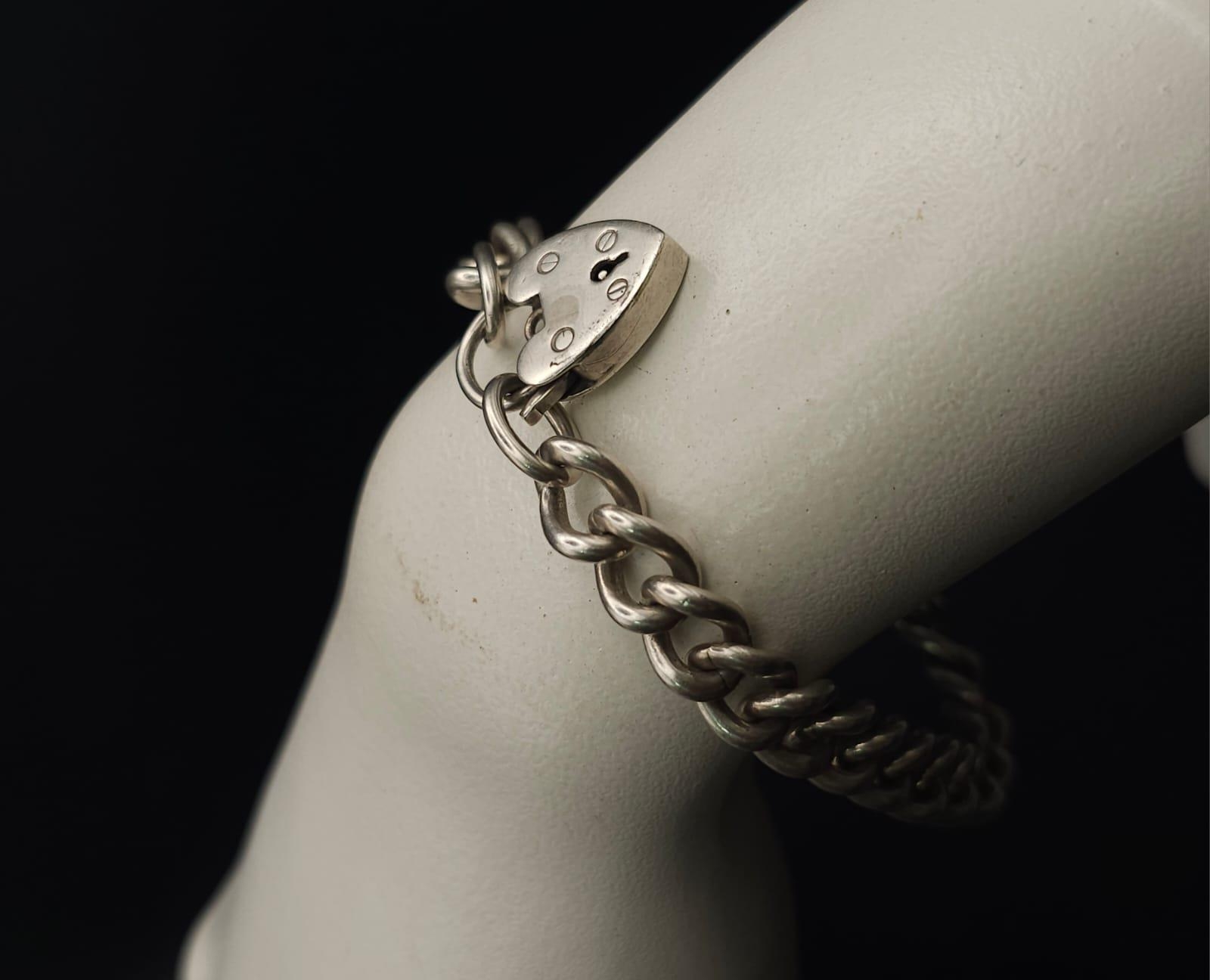 A Sterling silver chunky charm bracelet with heart padlock fastening. 31.6g - Image 7 of 7