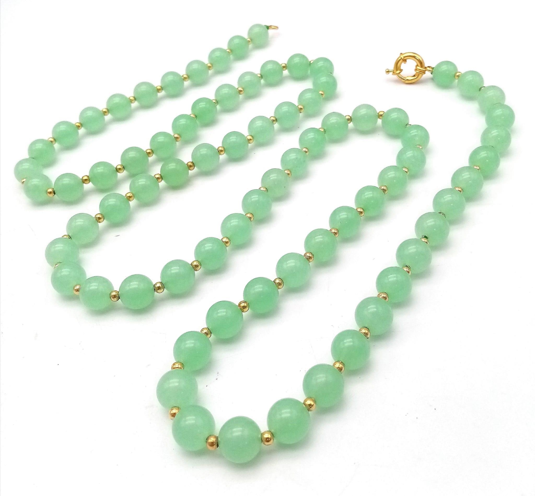 A Matinee Length Pale Green Jade Beaded Necklace. 10mm beads. Gilded spacers and clasp. 90cm - Image 2 of 2