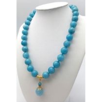 A Blue Aquamarine Beaded Necklace with Hanging Pendant. Gilded accents and clasp. 12mm beads. 42cm