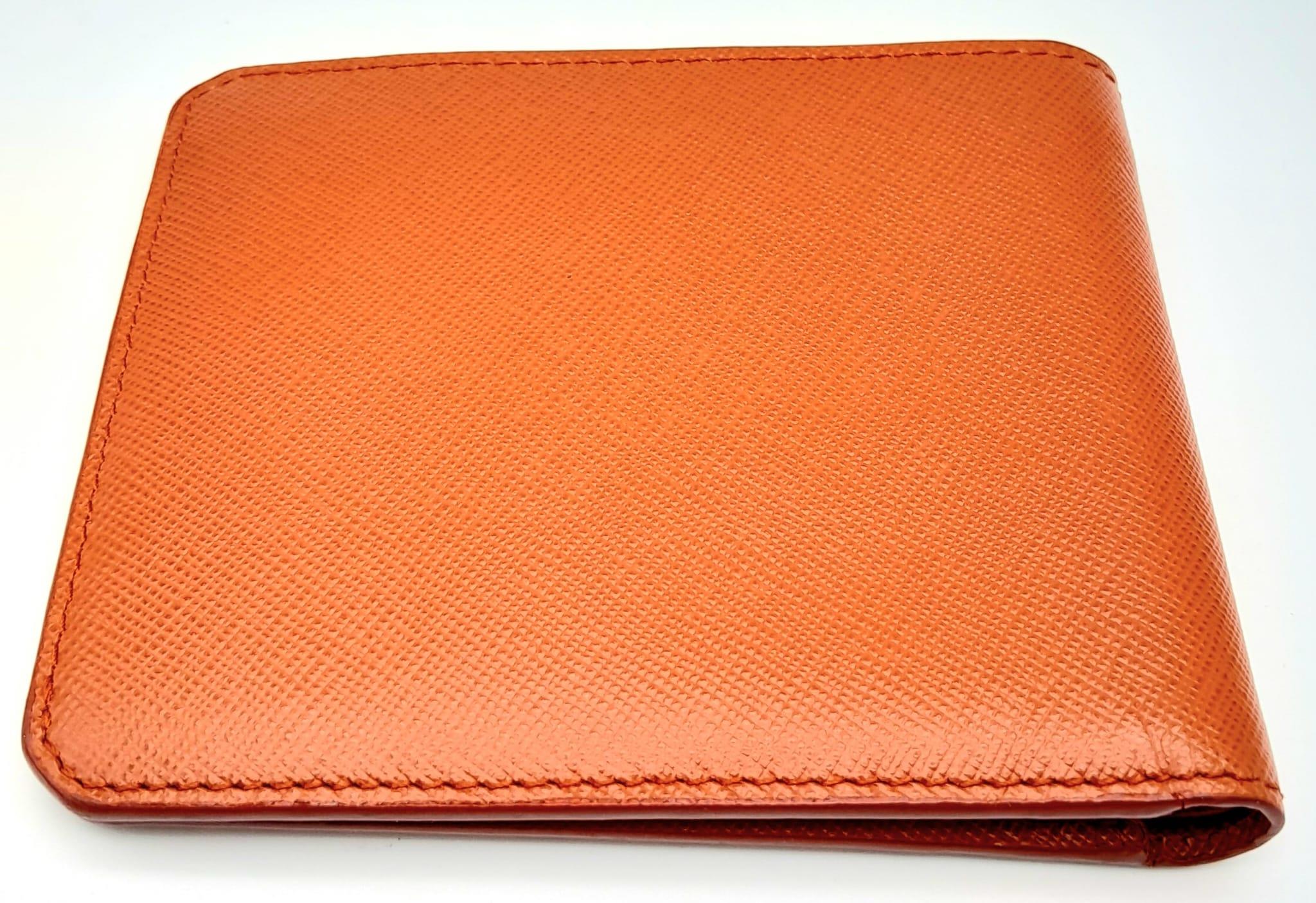 A Prada Burnt Orange Wallet. Leather exterior and interior, with silver-toned logo hardware. Two - Image 5 of 6