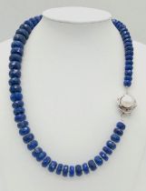 A 375ct Graduated Lapis Lazuli Faceted Bead Necklace with Pearl and 925 Silver Clasp. 44cm length.