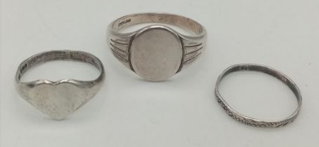 Trio of Sterling Silver rings. Thin band: Size J Oval Facet: Size T Love Heart: Size M Weight: 6.7g
