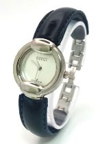 A Designer Gucci Quartz Ladies Watch. Blue leather and steel bracelet. Circular stainless steel case