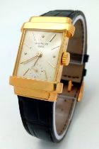 A Vintage Pater Philippe 18K Gold Gents Watch. Black leather strap with 18k gold buckle. 18k gold