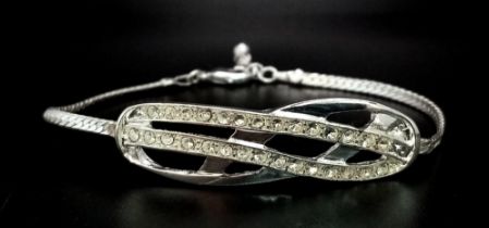 A very elegant, sterling silver bracelet with an eternity knot studded with clear stones. Weight: