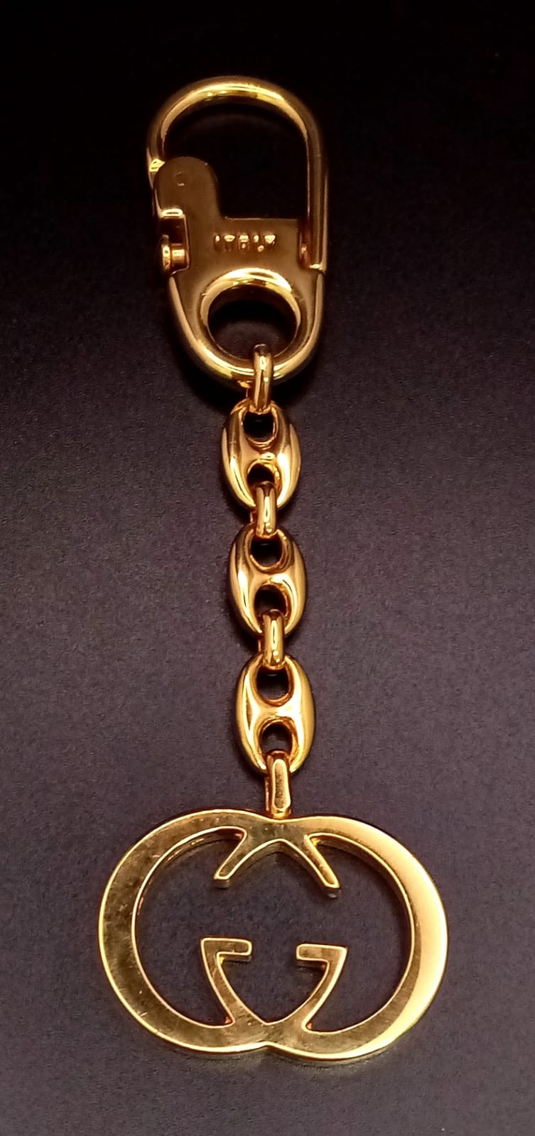 A Gucci Gold Plated Interlocking Keychain. This well constructed Gucci logo keychain is 12cm in