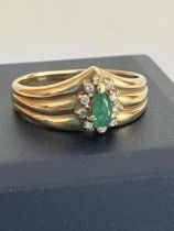 9 carat GOLD RING having a triple wishbone top,set with a GREEN TOURMALINE and a DIAMOND surround.