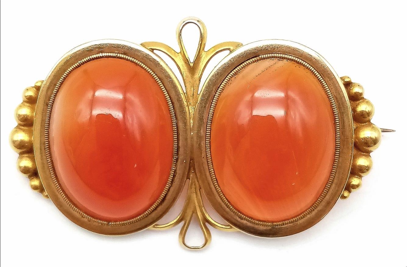 An Antique 18K Yellow Gold (tested) and Carnelian Brooch. Two rich orange cabochons of carnelian set - Image 3 of 4