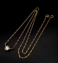 An 18K Yellow Gold Delicate Necklace with Attached Diamond Pendant. Brilliant round cut diamond.